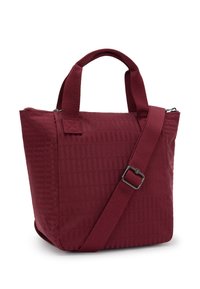 Burgundy tote bag with structured shape, textured fabric, double handles, and adjustable strap. Zipper closure at the top for security.