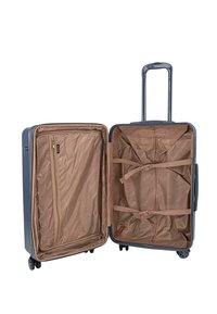 Maleta azul de carcasa dura con asa telescópica, cuatro ruedas giratorias y interior de tela beige con bolsillo con cremallera y correas ajustables.