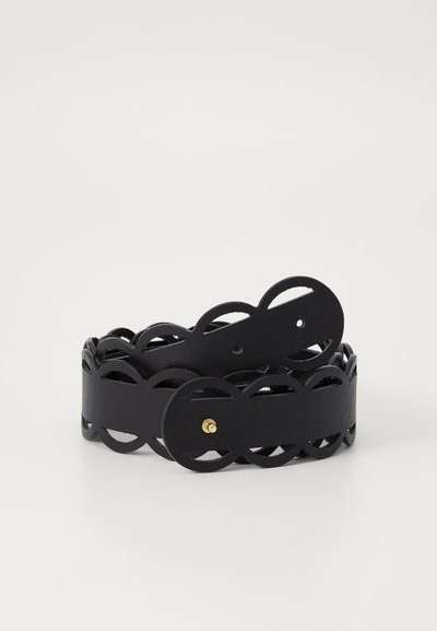 Black leather belt featuring a scalloped cut-out design, circular buckle with gold hardware, and smooth texture.