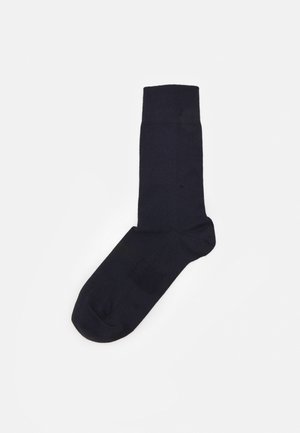 Navy cotton sock with a smooth texture, reinforced toe and heel, and a ribbed cuff. Designed for everyday wear.