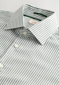 Gestreiftes Button-Down-Hemd aus grün-weißer Baumwolle. Verfügt über einen Kentkragen, zwei Knöpfe und dünne, gleichmäßig verteilte Streifen.