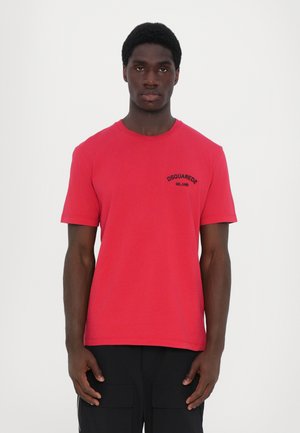 Red cotton t-shirt features a round neckline and short sleeves. It has a small black logo on the left chest area.