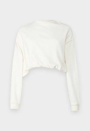 Skraćeni dukserica dugih rukava u off-white pamučnom materijalu. Ima okrugli izrez i rebraste manžetne. Glatka tekstura s opuštenim krojem.