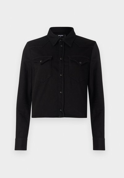 Black cropped denim shirt with long sleeves, point collar, front snap button closure, and two chest pockets. Features contrasting stitching details.