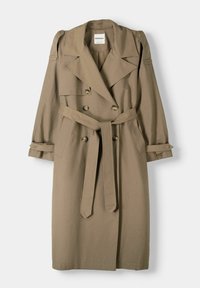 Kaki trenchcoat med dubbla knappar, breda slag och ett justerbart bälte. Har långa ärmar med uppvikta cuffar och en mjuk yta.