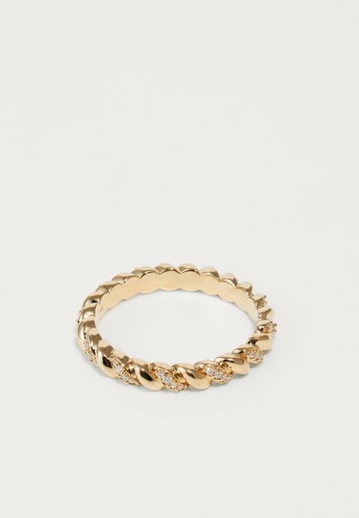 Gold ring featuring a twisted design, adorned with small crystals, showcasing a smooth, reflective surface and circular shape.