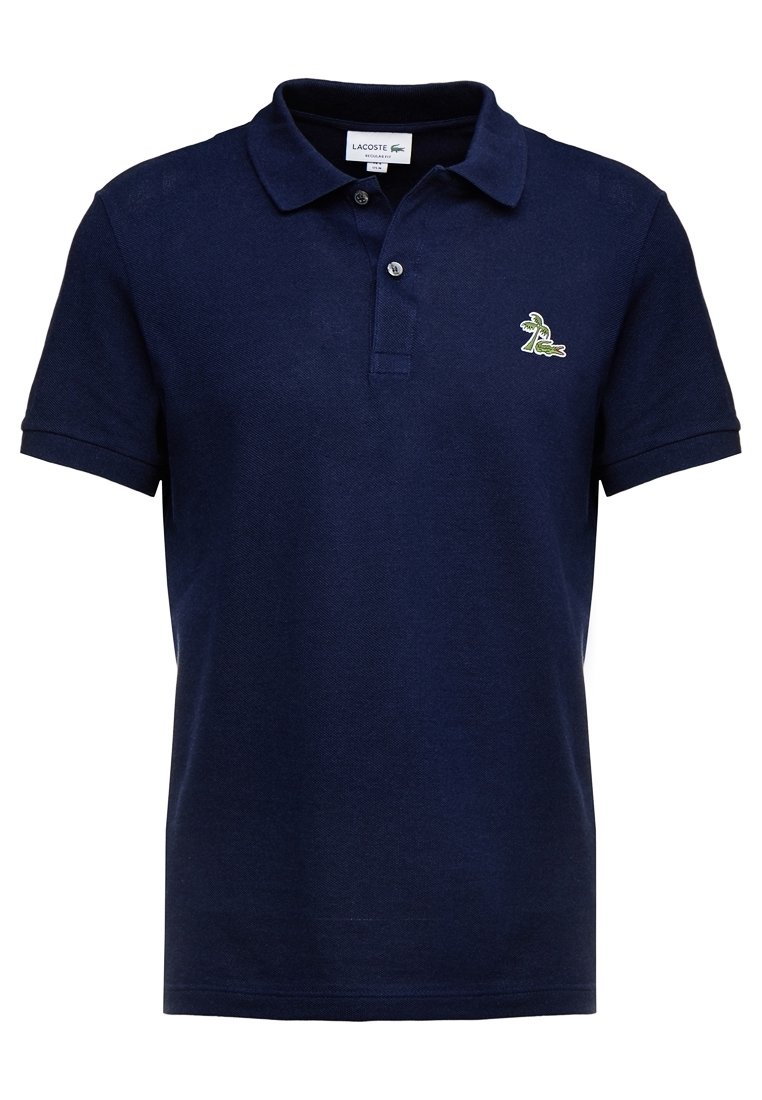 Granatowa koszulka polo wykonana z teksturowanej bawełny, z klasycznym kołnierzykiem, trzema guzikami i małym zielonym haftowanym logo krokodyla.