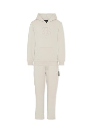 Ensemble composé d'un sweat à capuche beige clair et d'un pantalon de jogging assorti. Le sweat à capuche présente une poche frontale et un détail de logo, avec des poignets et un ourlet côtelés. Texture de tissu douce.