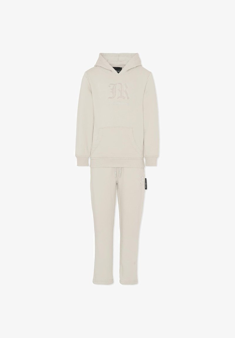 Completo di felpa e pantaloni della tuta in beige chiaro. La felpa presenta una tasca frontale e un logo, con polsini e orlo a costine. Tessuto morbido.