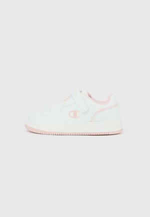 White and pink low-top sneaker with Velcro strap, laces, and logo on the side, designed for casual wear.