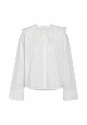 Valge pika varrukaga särk, millel on suur, tikitud lainelise äärega krae, millel on õrn roosa ääristus. Lihtne kangas, veidi lõdvestunud istuvus, nööpkinnitusega.