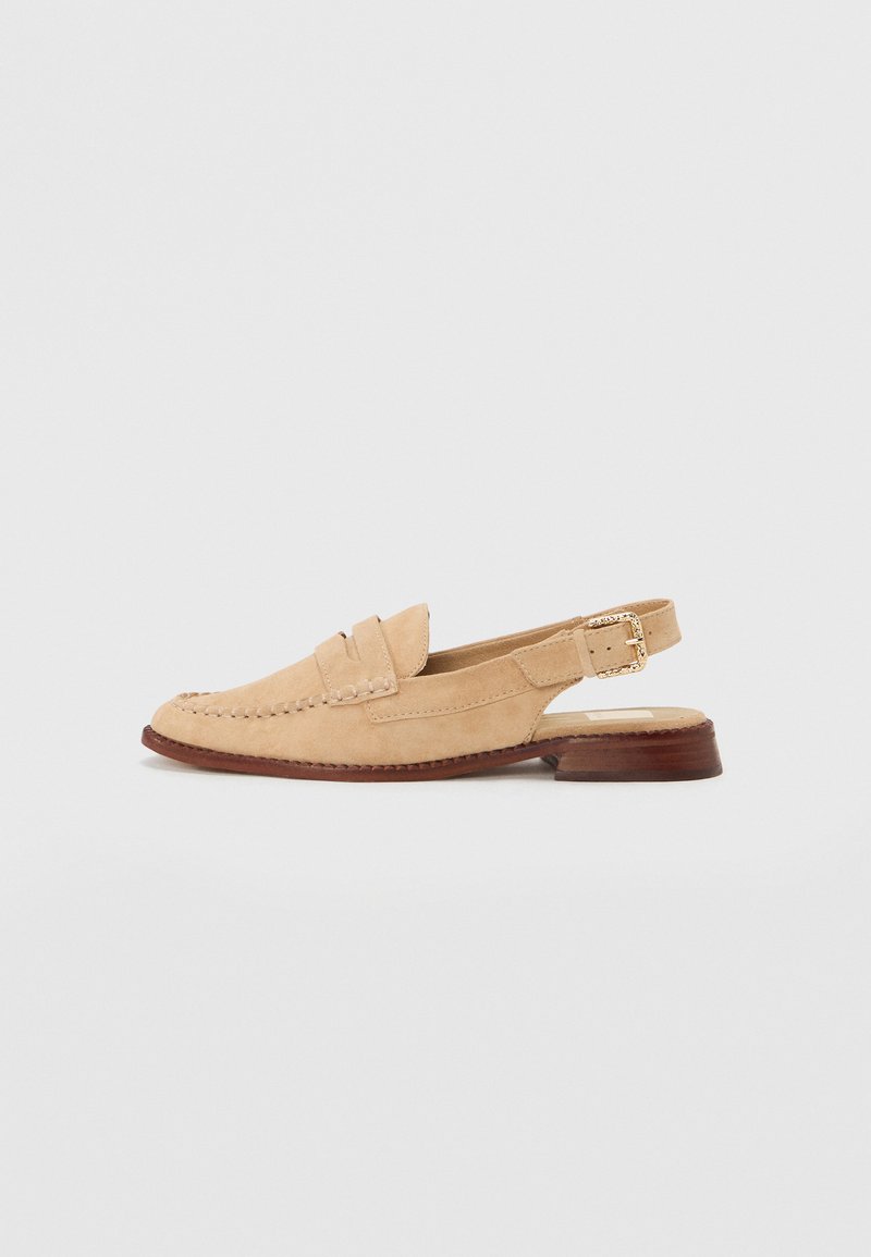 Beige suede slingback shoe with a small heel, featuring a stitched detail on the toe and a gold-tone buckle on the ankle strap.