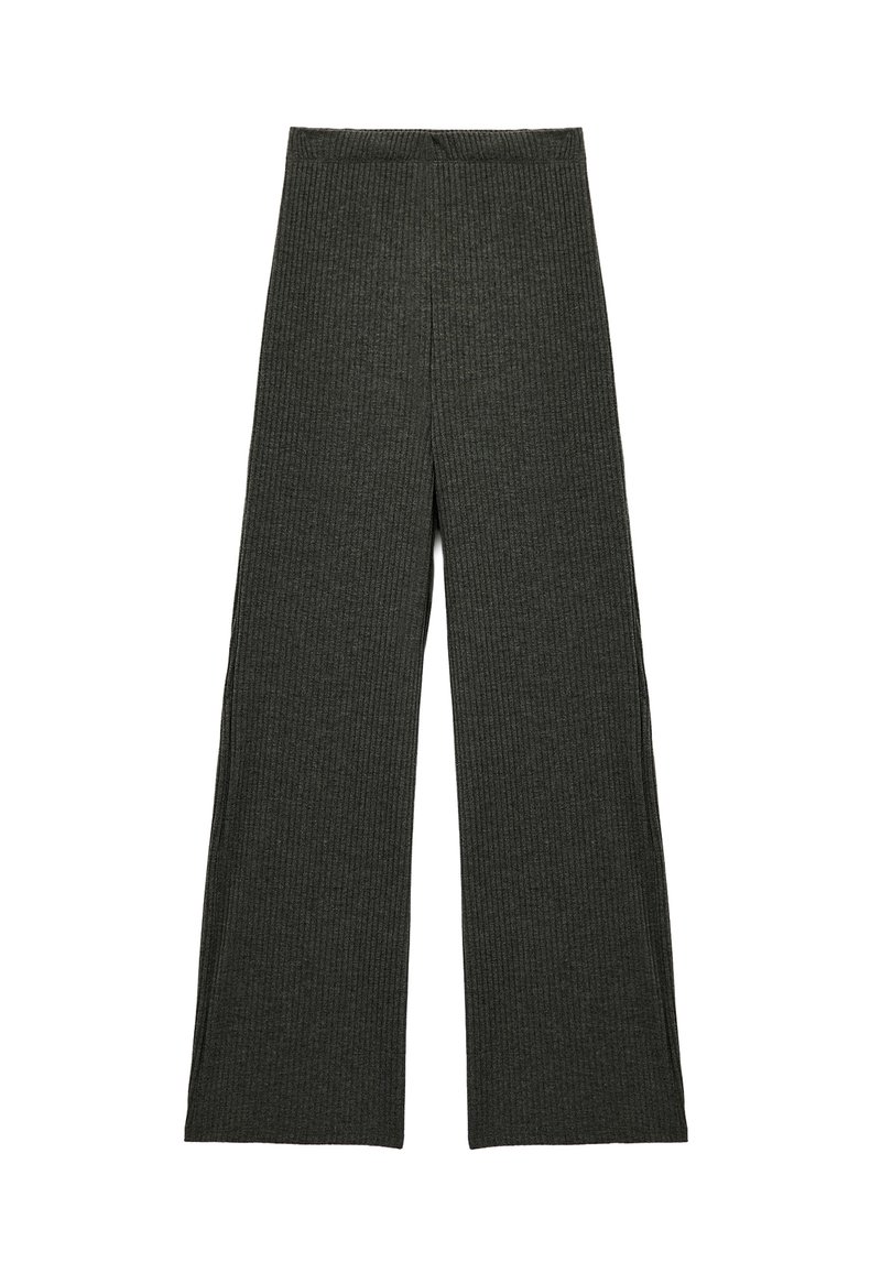 Dunkelgrüne, gerippte, weite Hosen mit elastischem Bund. Der Stoff hat ein strukturiertes Muster und eine lockere, fließende Silhouette.