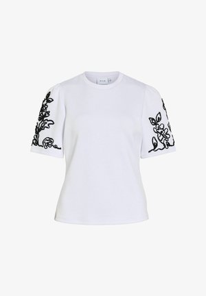 Fehér rövid ujjú ing, puffadt ujjakkal, fekete virágos hímzéssel mindkét karon, kerek nyakkivágással.