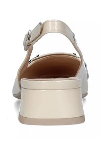 Sandalo in pelle verniciata beige con cinturino regolabile, tacco arrotondato e texture liscia. Fodera interna di colore neutro; vista posteriore che mette in evidenza l'altezza del tacco.