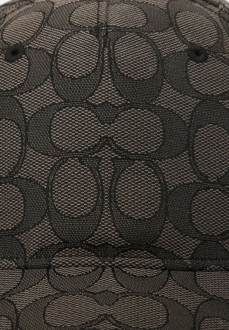 Schwarze Stoff-Baseballmütze mit einem geprägten kreisförmigen Muster, das eine strukturierte Oberfläche und eine abgerundete Krone aufweist.