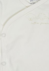 White baby onesie with snap buttons and light beige animal faces and "little friends" text on the chest.