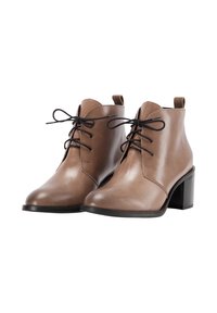 Scarpe ankle in pelle marrone con lacci neri, punte rotonde, linguette per l'aggancio e tacchi a blocco su sfondo bianco.