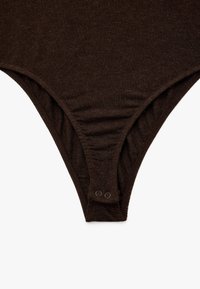 Brązowy, bawełniany bodysuit o dopasowanym kroju, z marszczonymi szwami bocznymi i zapięciem na napy w kroku dla wygody.