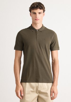 Olive green polo shirt made of cotton, featuring a collared neckline, three-button placket, and short sleeves with a slim fit.