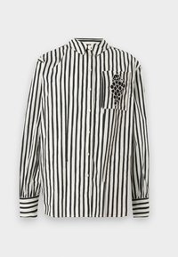 Camicia a righe bianche e nere con colletto button-down, maniche lunghe e taschino sul petto sinistro con un design di uva. Materiale in cotone.