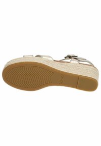 Wedge sandal with a metallic silver upper, woven jute platform, and textured rubber sole featuring a zigzag pattern. Adjustable ankle strap.