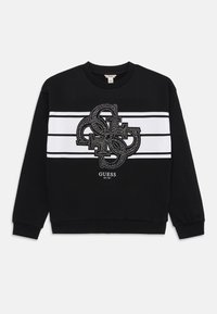 Sweatshirt noir avec un logo décoratif central en strass, des rayures blanches sur la poitrine et des poignets et ourlet côtelés.