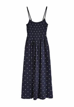 Tamsiai mėlyna rankovių neturinti suknelė su baltais taškeliais, susmulkintu aptemptu viršutiniu diržu ir plonomis petnešėlėmis, besiveržianti žemiau liemens.