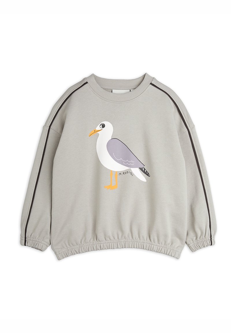 Pull léger gris clair à manches longues avec ourlet élastique et bande noire sur les manches, avec une mouette dessin animé avec un bec et des pattes orange à l'avant.