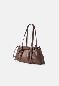 Brown leather handbag with a textured finish, featuring two long handles, gathered detailing, and gold-tone hardware accents.
