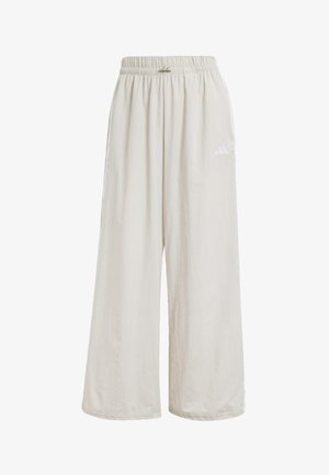 Vaaleanbeiget leveälahkeiset housut, joissa on joustava vyötärö ja huomaamattomat sivuviivat. Valmistettu sileästä kankaasta, jossa on pieni logotiedosto.