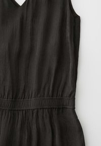 Sleeveless black textured dress with a V-neck and gathered elastic waistband, displayed flat on a white background.