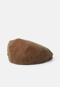 Bérêt en coton ciré marron de style circulaire, présentant deux trous de ventilation de chaque côté et une finition texturée.