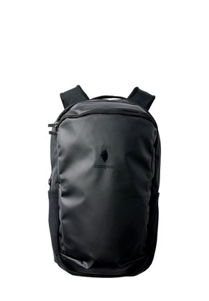 Black Cotopaxi backpack with a smooth front surface, two shoulder straps, side pockets, and a zippered top compartment.