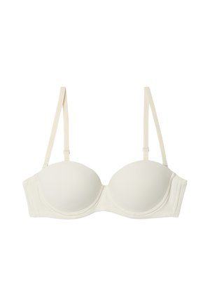 Underwired bra in cream fabric with smooth molded cups, adjustable straps, and a side closure. Features minimal design with no patterns.