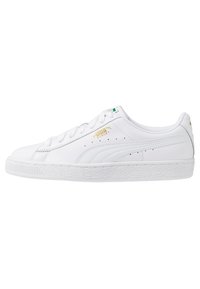 Bílé kožené tenisky s texturovanou gumovou podrážkou, s zlatými akcenty a perforovanými detaily po stranách a na jazyku.