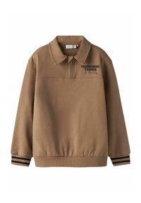 Rudos spalvos megztinis su apykakle, elastingu apačios kraštu ir dryžuotais rankogaliais. Ant krūtinės juodu rašmenimis užrašyta „TOURNAMENT TENNIS“. Minkšta audinio tekstūra.