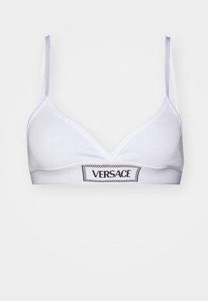 Valge rinnahoidja, mis on valmistatud soonikust kangast, kolmnurksete tassidega ja musta "VERSACE" logo riba. Õhukesed rihmad heledashallis värvitoonis.