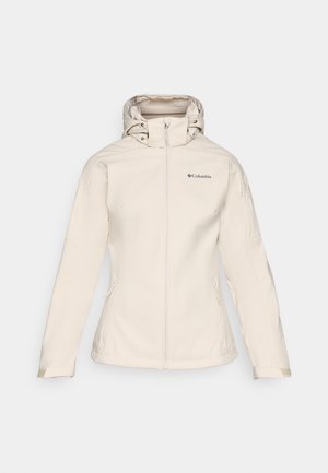 Vrouwen beige softshelljack met een rits aan de voorkant, verstelbare capuchon en twee zijzakken. Heeft een gladde textuur en subtiele branding.