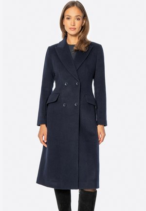 Marineblauer Wollmisch-Doppelreihermantel mit großen Revers, Seitentaschen und mittellanger Schnitt. Glatte Textur, taillierte Passform.