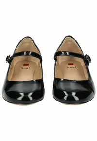 Scarpe Mary Jane in pelle verniciata nera con punta arrotondata, cinturino alla caviglia e piccola fibbia. Texture liscia e solette beige.