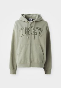 Olive green zip-up hoodie with a front kangaroo pocket, embroidered "OBEY" logo in a contrasting darker green, and drawstring hood.