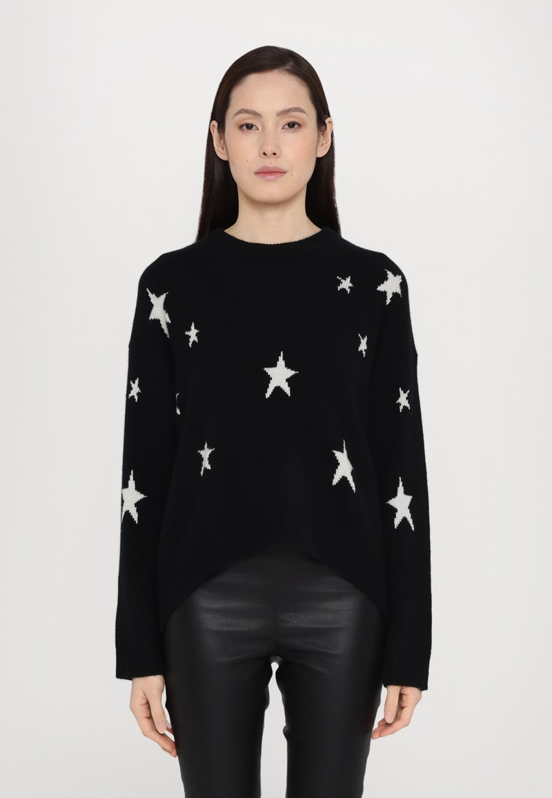 Black sweater with white star patterns, crew neckline, long sleeves, and a high-low hem. Made of soft, textured knit material.