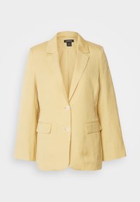 Blazer femme jaune clair avec revers crantés, deux poches avant à rabat et deux boutons blancs, présenté sur fond blanc.