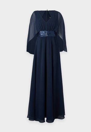 Laivansiniset pitkähelmaiset mekko, jossa on V-pääntie ja läpikuultavat viittahihat. Kimalteleva vyötärönauha lisää rakennetta ja hohtoa. Pehmeä, virtaava kangas.