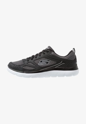 Black athletic shoes with a breathable mesh upper, white midsole, and subtle detailing. Features a lace-up design and contoured shape.