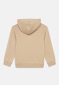 Beige long-sleeve hoodie with ribbed cuffs and hem, shown from the back on a white background.