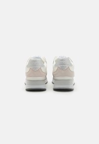 White and light pink sneakers with grey soles, featuring a mix of materials including smooth leather and soft suede, with shiny accents.