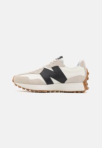 Running shoes with a white and beige suede and leather upper, featuring a large black logo, a rubber sole, and textured accents.
