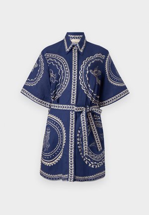 Tamsiai mėlyna marškinėlių suknelė trumpomis rankovėmis, su baltais siuvinėtų apvalių raštų akcentais ir diržu, kuris formuoja apibrėžtą siluetą.